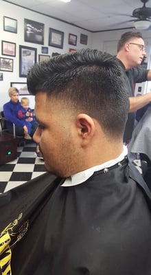 Walk-in client showing a freshly cut style from Ernie's in Olathe